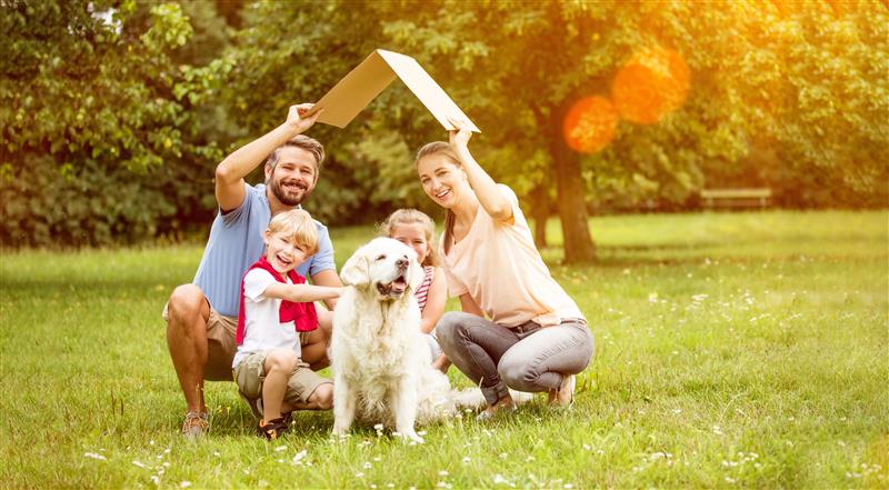 Happy family with their dog, representing life insurance security